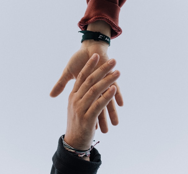 close up of two hands trying to connect with each other.