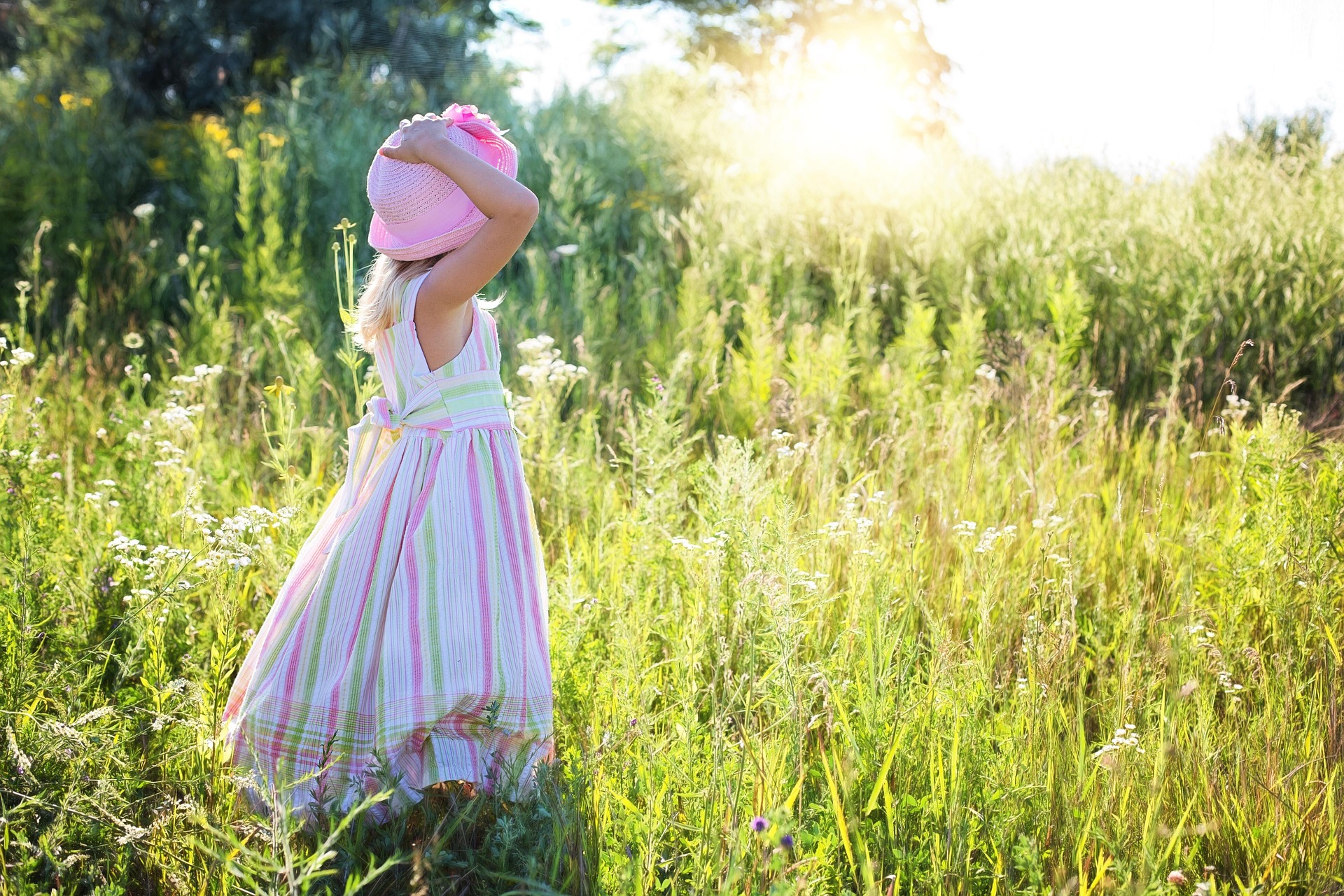 a little girl watching sunrise standing on a grass land world merchant investment cover image
